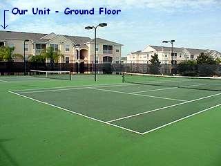 Tennis courts with condos in background